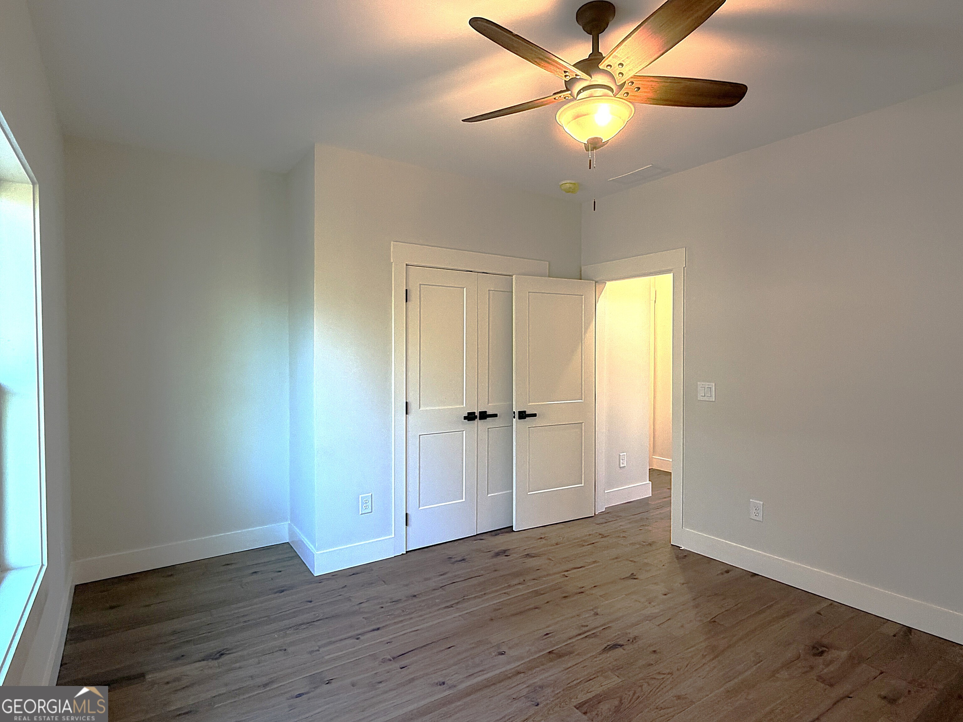 438 Mill Ridge Road Hiawassee, GA 30546 - Photo 21 of 75 a view of an empty room and window with wooden floor