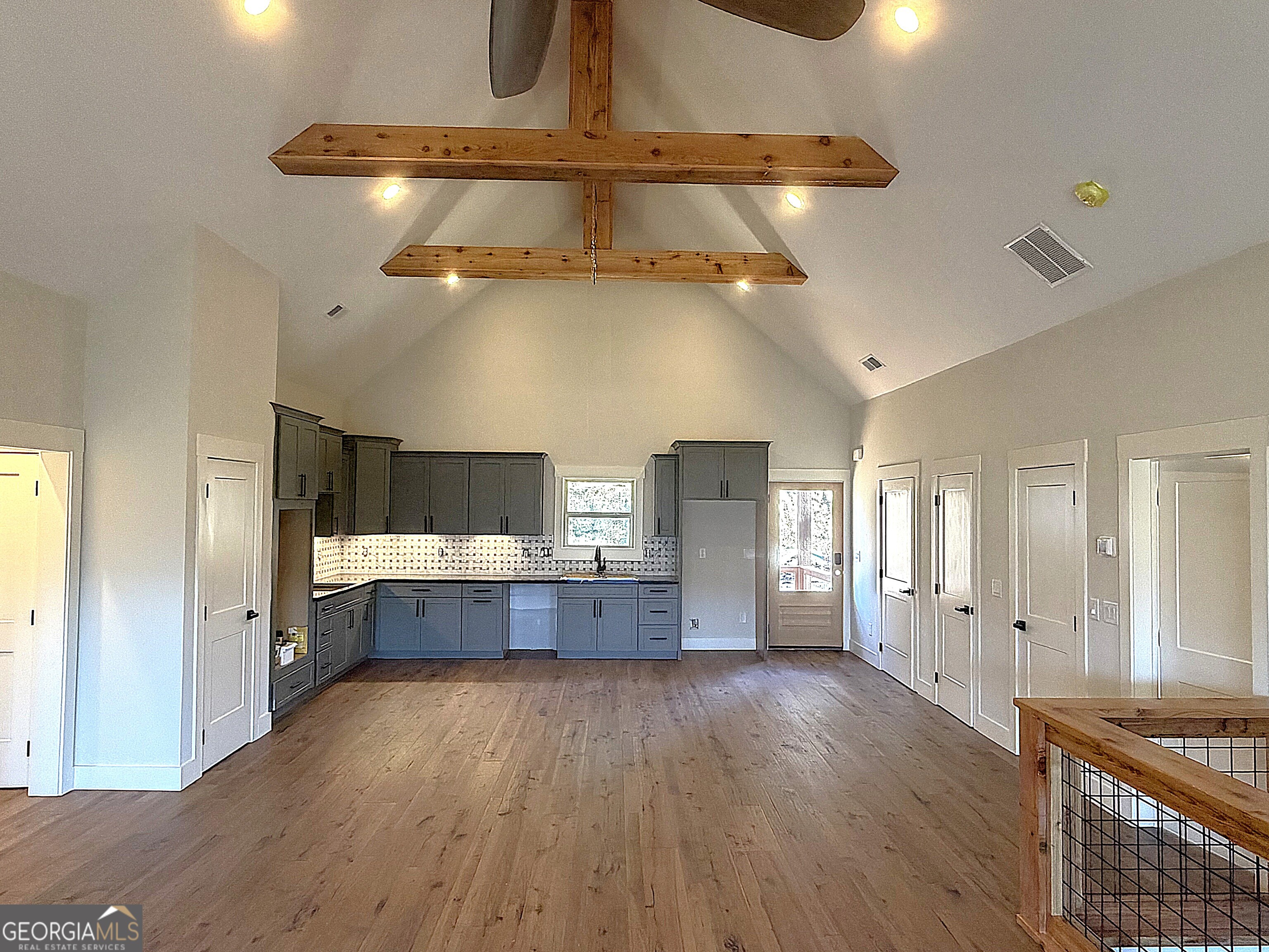 438 Mill Ridge Road Hiawassee, GA 30546 - Photo 5 of 75 a large kitchen with a wooden floor and cabinets