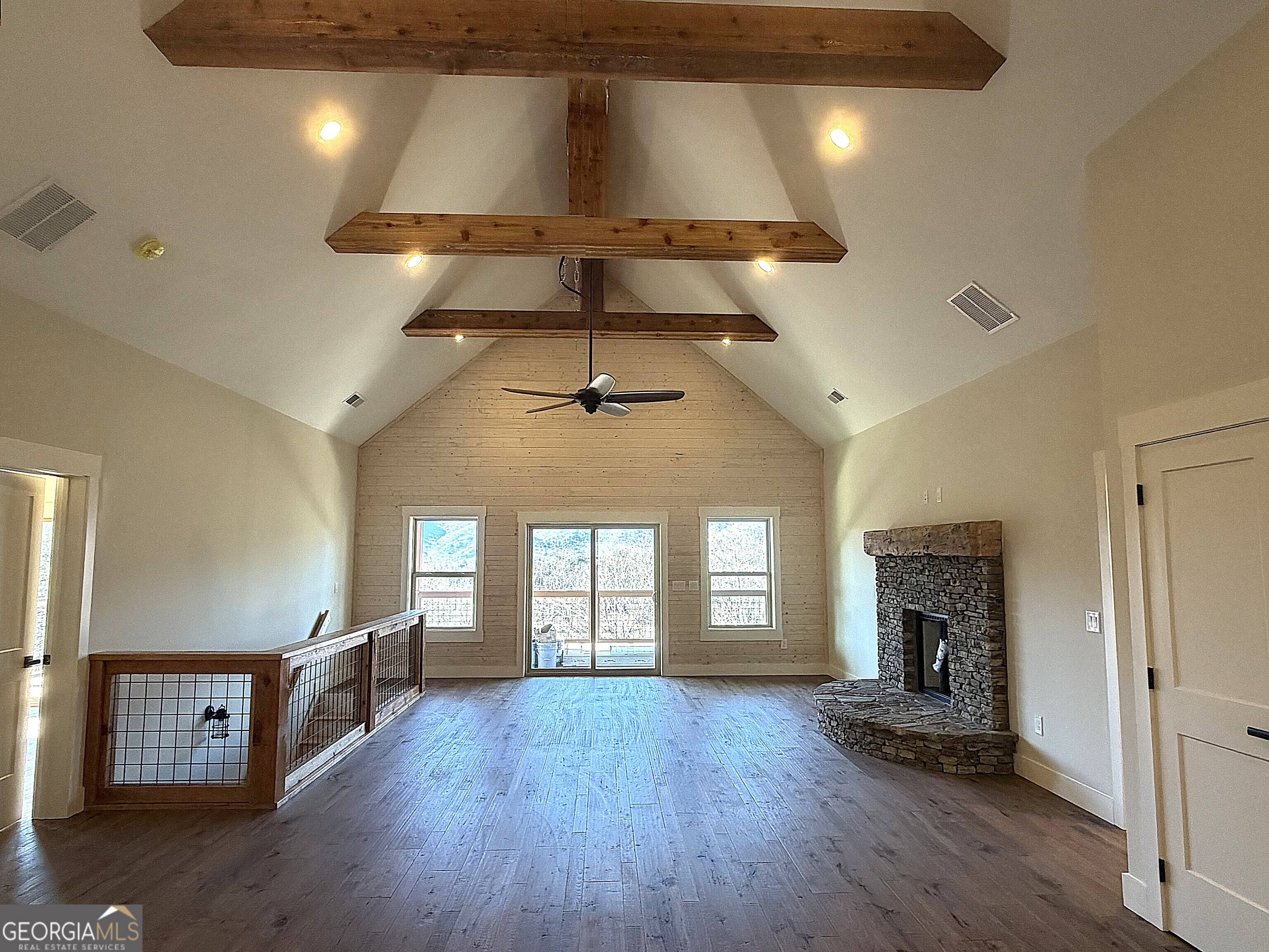 438 Mill Ridge Road Hiawassee, GA 30546 - Photo 7 of 75 a view of an empty room with a fireplace and wooden floor