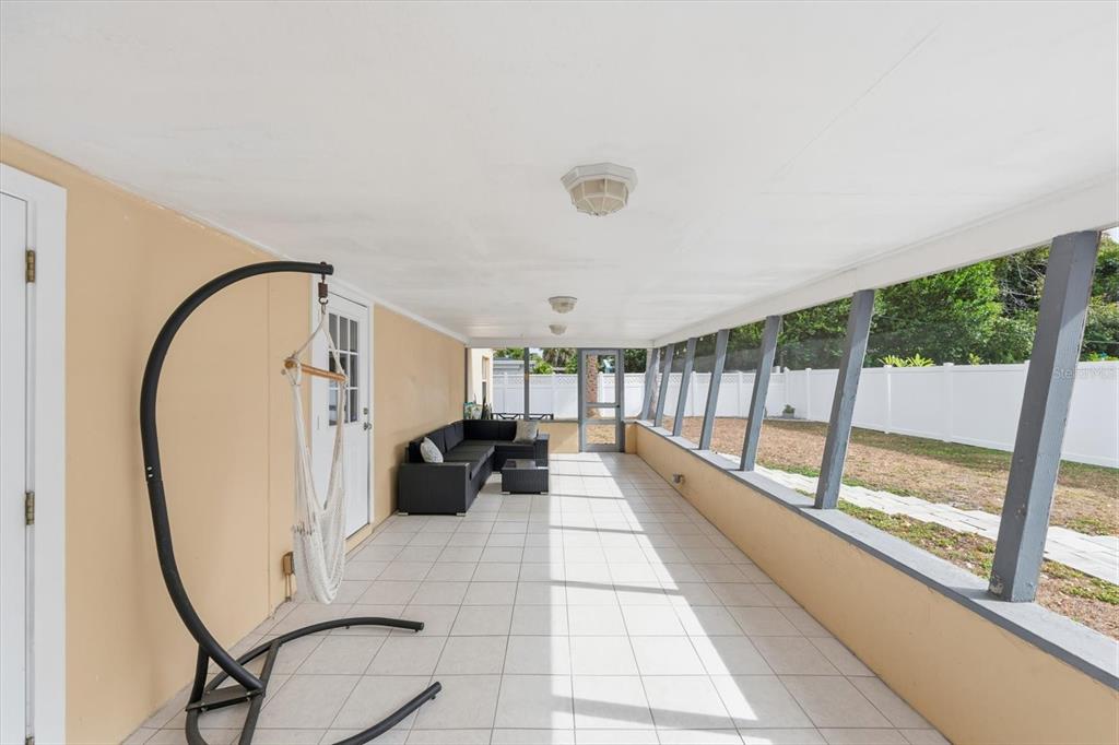 1439 Wilson Road Clearwater, FL 33755 - Photo 20 of 26 a living room with furniture and a floor to ceiling window