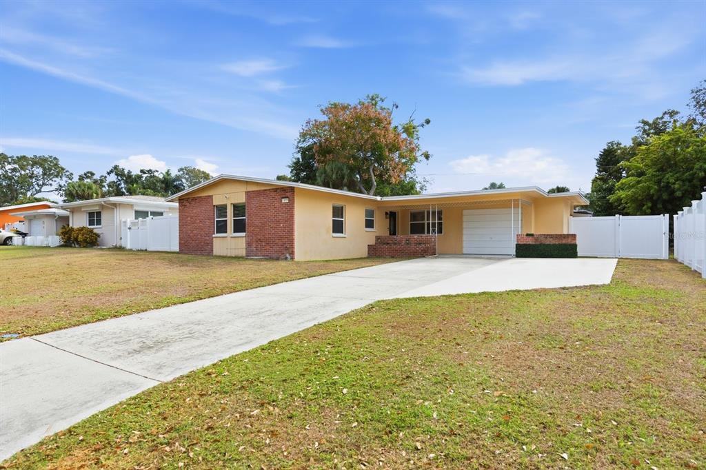 1439 Wilson Road Clearwater, FL 33755 - Photo 2 of 26 a front view of a house with a yard