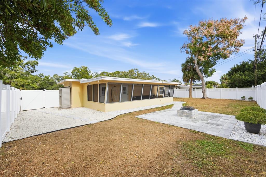 1439 Wilson Road Clearwater, FL 33755 - Photo 25 of 26 a house with trees in the background