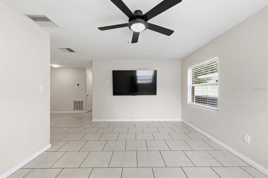 1439 Wilson Road Clearwater, FL 33755 - Photo 4 of 26 a view of a livingroom with a chandelier fan and windows