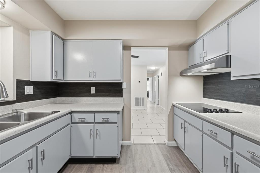 1439 Wilson Road Clearwater, FL 33755 - Photo 6 of 26 a kitchen with cabinets and white appliances