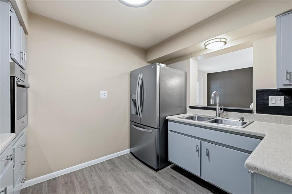 1439 Wilson Road Clearwater, FL 33755 - Photo 8 of 26 a kitchen with a sink and refrigerator