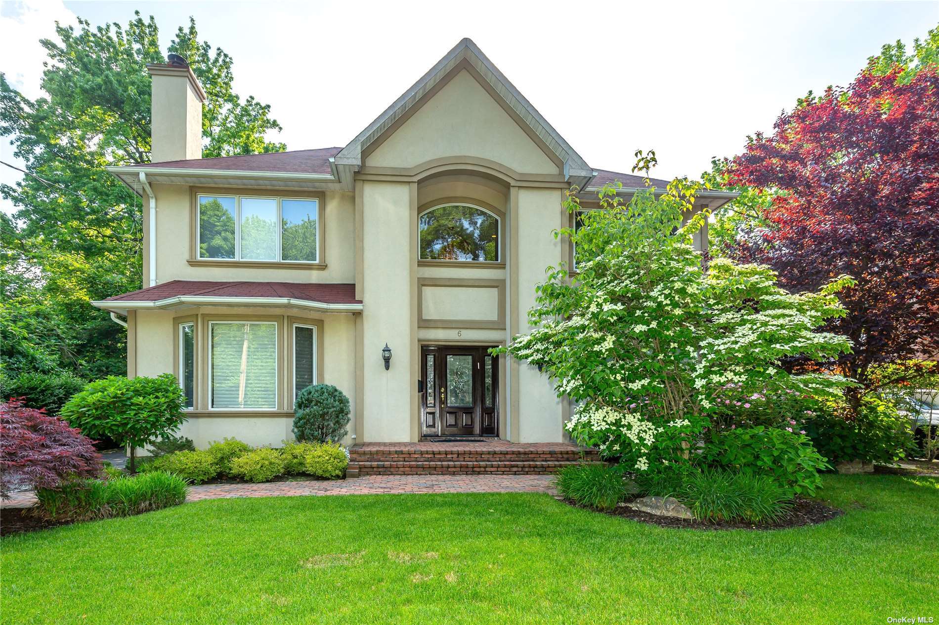 6 South Gate Road Great Neck, NY 11023 - Photo 1 of 1 a front view of a house with a garden