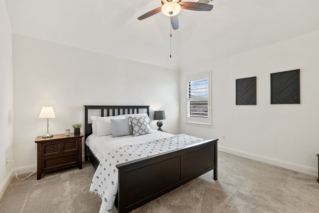 5812 Davenport Divide Road Austin, TX 78738 - Photo 27 of 40 Vaulted ceilings and neutral carpeting create a bright, calming bedroom retreat.