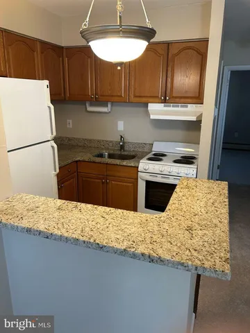 a kitchen with granite countertop cabinets and steel stainless steel appliances