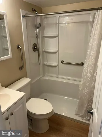 a bathroom with a shower a toilet and a shower