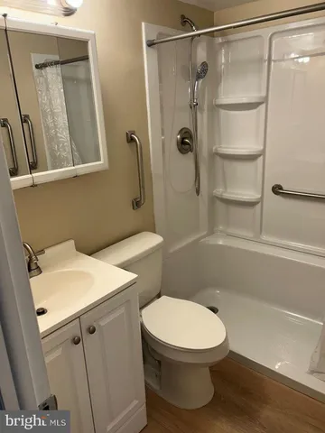 a bathroom with a toilet and a shower