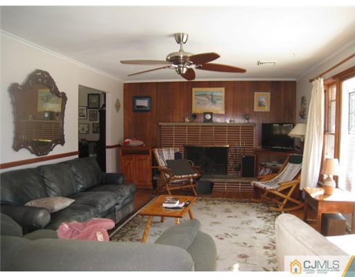 32 Middlesex Road Old Bridge, NJ 07747 - Photo 2 of 8 a living room with furniture a window and a fireplace
