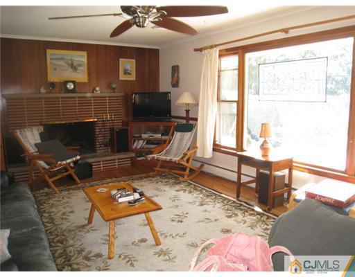 32 Middlesex Road Old Bridge, NJ 07747 - Photo 6 of 8 a living room with furniture a rug and a floor to ceiling window