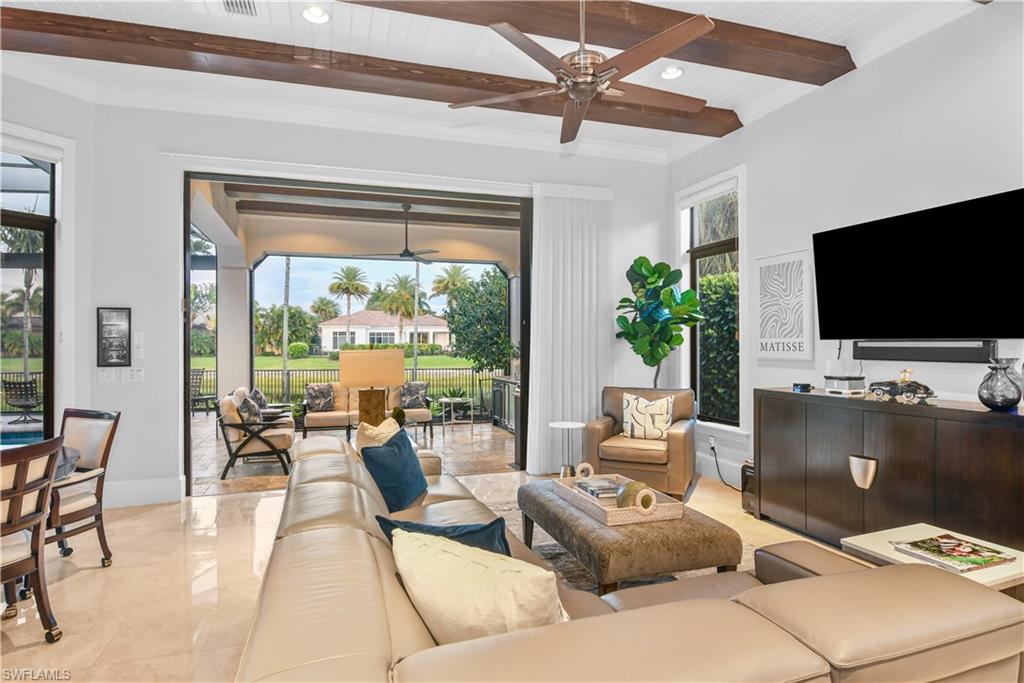 2220 Residence Circle Naples, FL 34105 - Photo 13 of 50 a living room with furniture and a flat screen tv