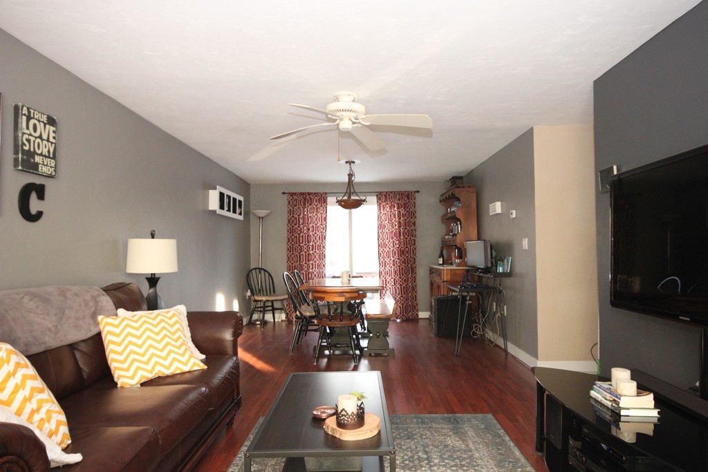 1 Country Side Road, Unit 1 Bellingham, MA 02019 - Photo 5 of 20 a living room with furniture and a flat screen tv