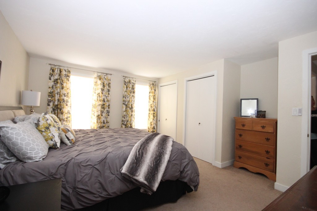 1 Country Side Road, Unit 1 Bellingham, MA 02019 - Photo 8 of 20 a bedroom with a bed and a closet