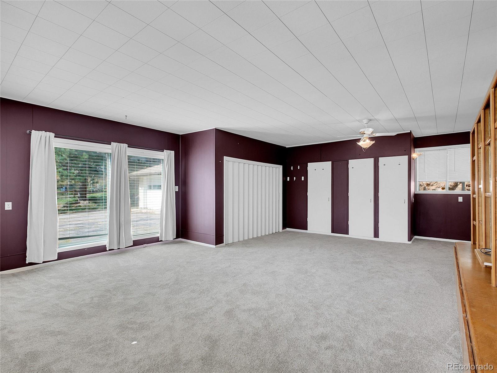 28449 Douglas Park Road Evergreen, CO 80439 - Photo 12 of 25 a view of an empty room with a window and a kitchen