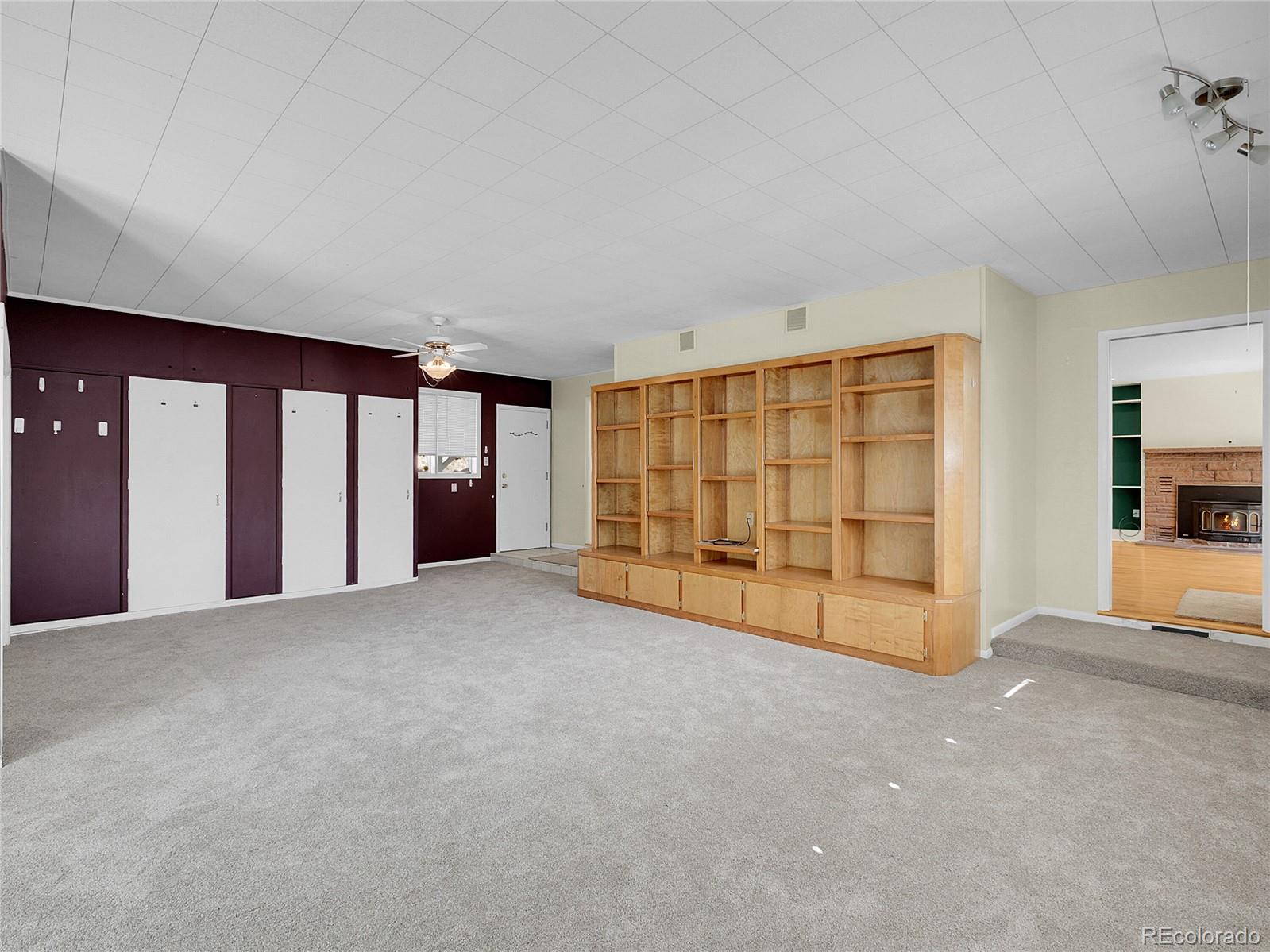 28449 Douglas Park Road Evergreen, CO 80439 - Photo 13 of 25 a view of an empty room with a fireplace and window