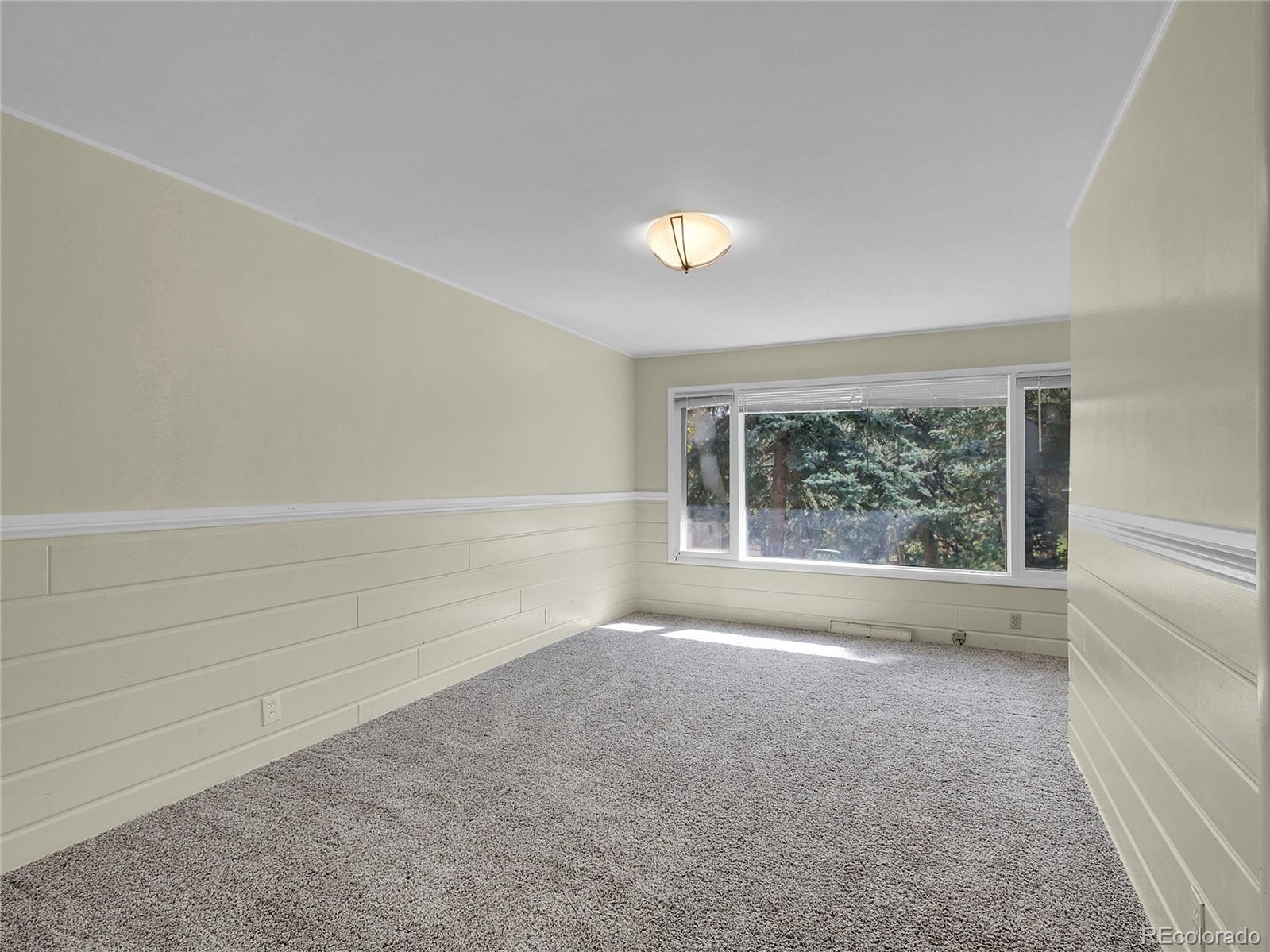 28449 Douglas Park Road Evergreen, CO 80439 - Photo 17 of 25 a view of an empty room with a window