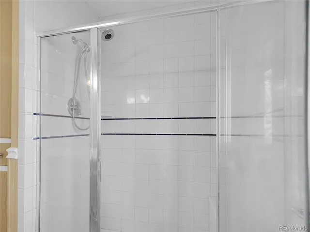 a bathroom with a glass shower door