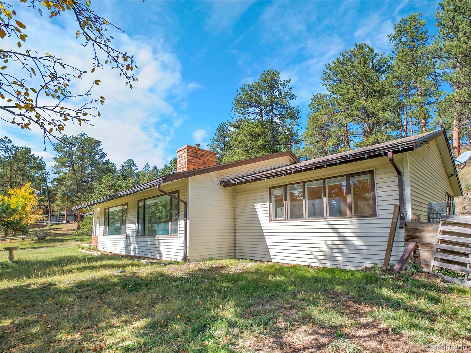 28449 Douglas Park Road Evergreen, CO 80439 - Photo 2 of 25 a view of a house with a yard