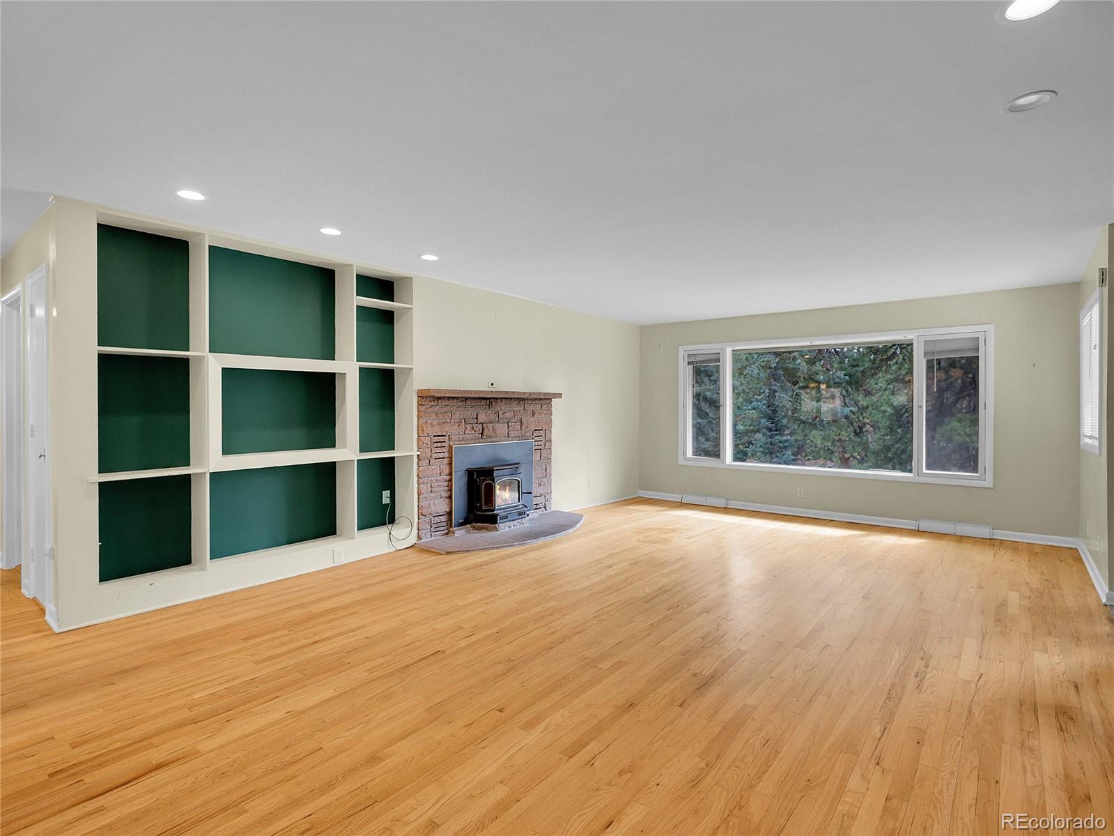 28449 Douglas Park Road Evergreen, CO 80439 - Photo 3 of 25 a view of an empty room with a window and wooden floor