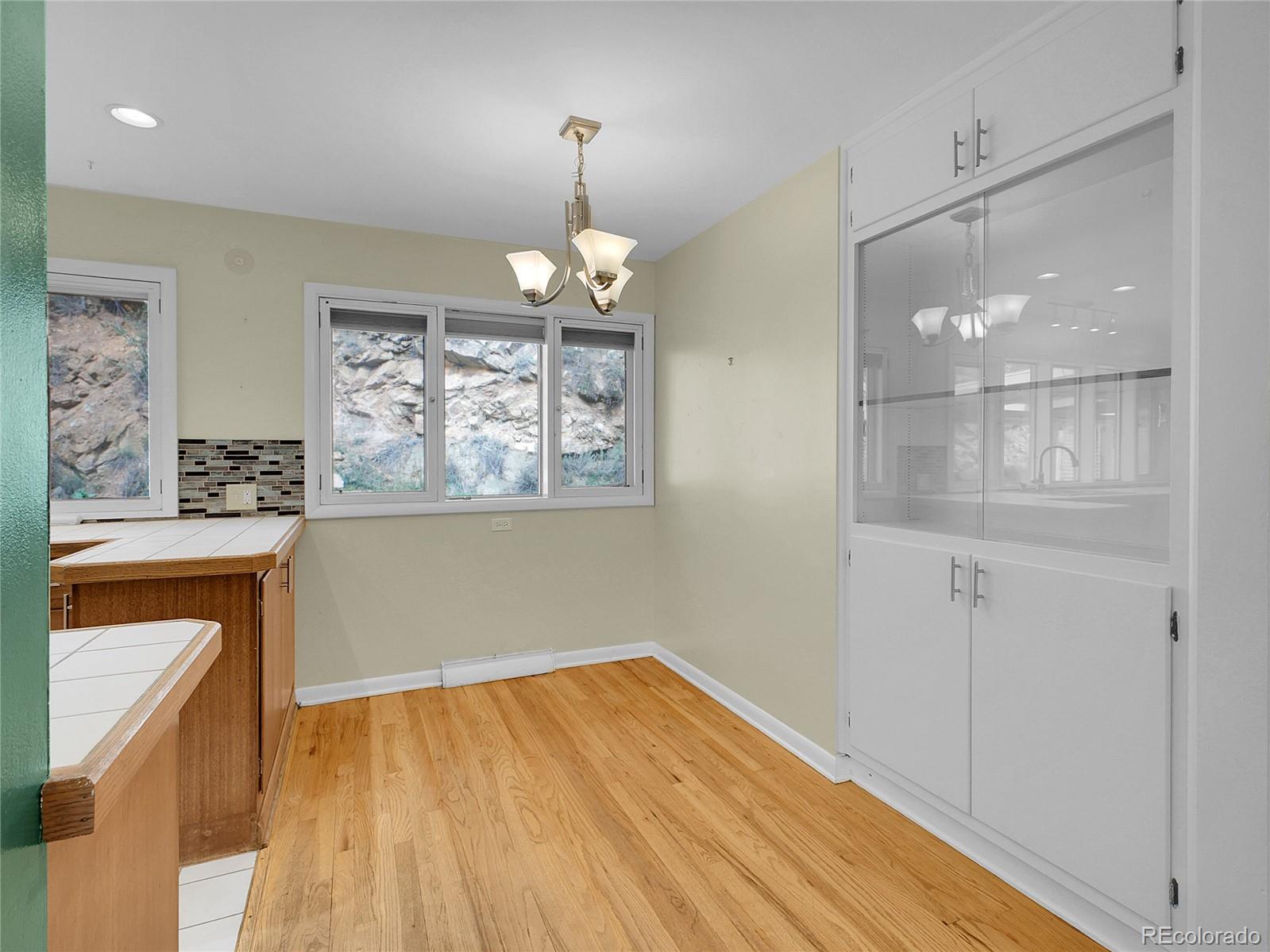 28449 Douglas Park Road Evergreen, CO 80439 - Photo 5 of 25 a view of a room with wooden floor and chandelier