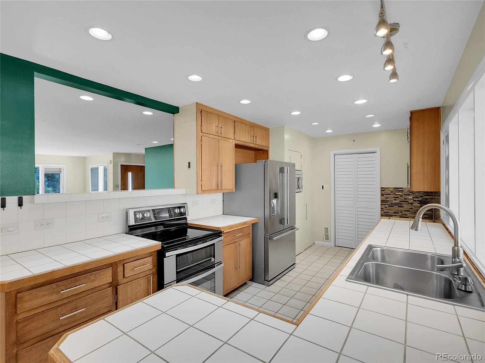 28449 Douglas Park Road Evergreen, CO 80439 - Photo 7 of 25 a kitchen with stainless steel appliances granite countertop a sink and cabinets