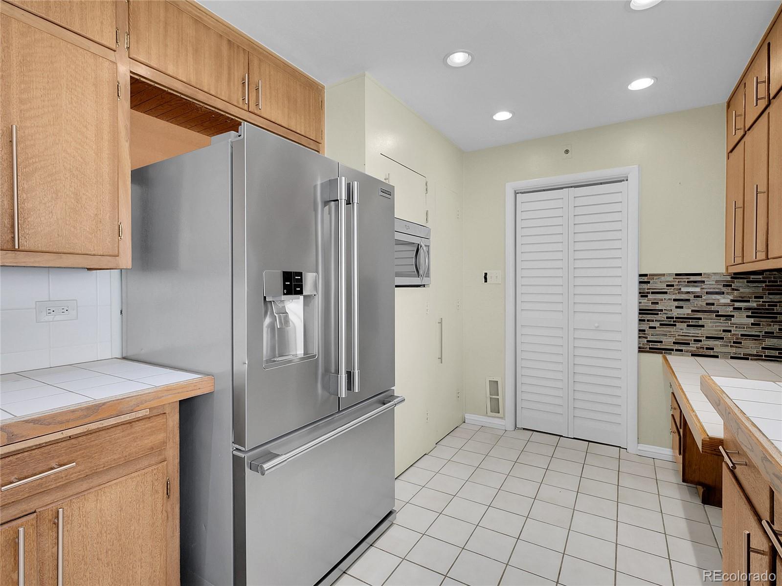 28449 Douglas Park Road Evergreen, CO 80439 - Photo 10 of 25 a kitchen with a refrigerator and a sink
