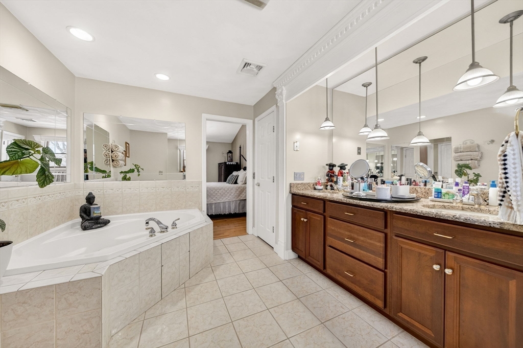 155 Sagamore Road Seekonk, MA 02771 - Photo 24 of 41 a large kitchen with kitchen island a counter a sink and cabinets