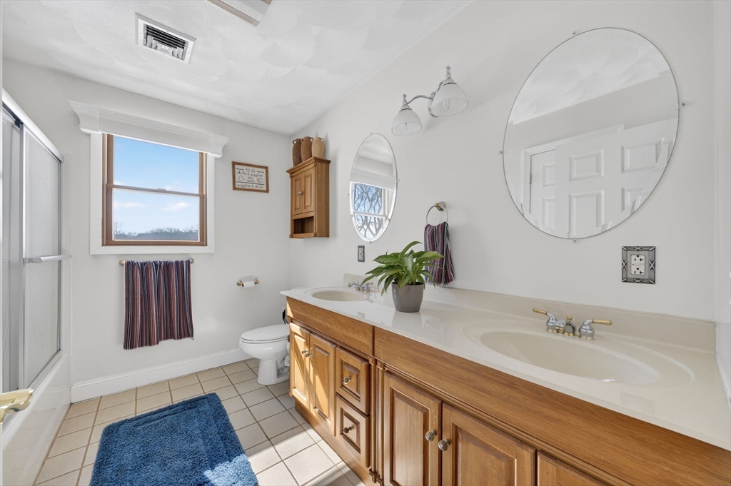 155 Sagamore Road Seekonk, MA 02771 - Photo 28 of 41 a bathroom with a granite countertop sink a mirror and a shower