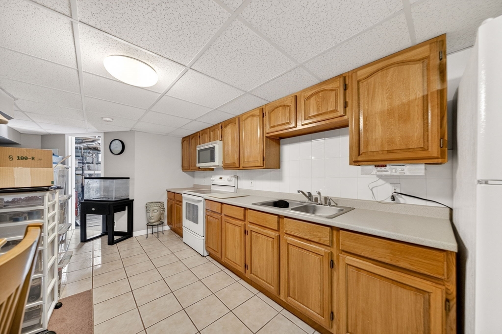 155 Sagamore Road Seekonk, MA 02771 - Photo 32 of 41 a kitchen with stainless steel appliances granite countertop a sink and cabinets