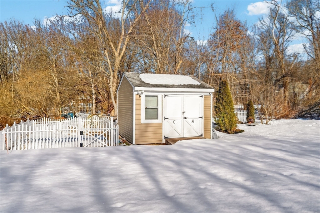 155 Sagamore Road Seekonk, MA 02771 - Photo 35 of 41 a view of a house with a wooden fence and a large tree