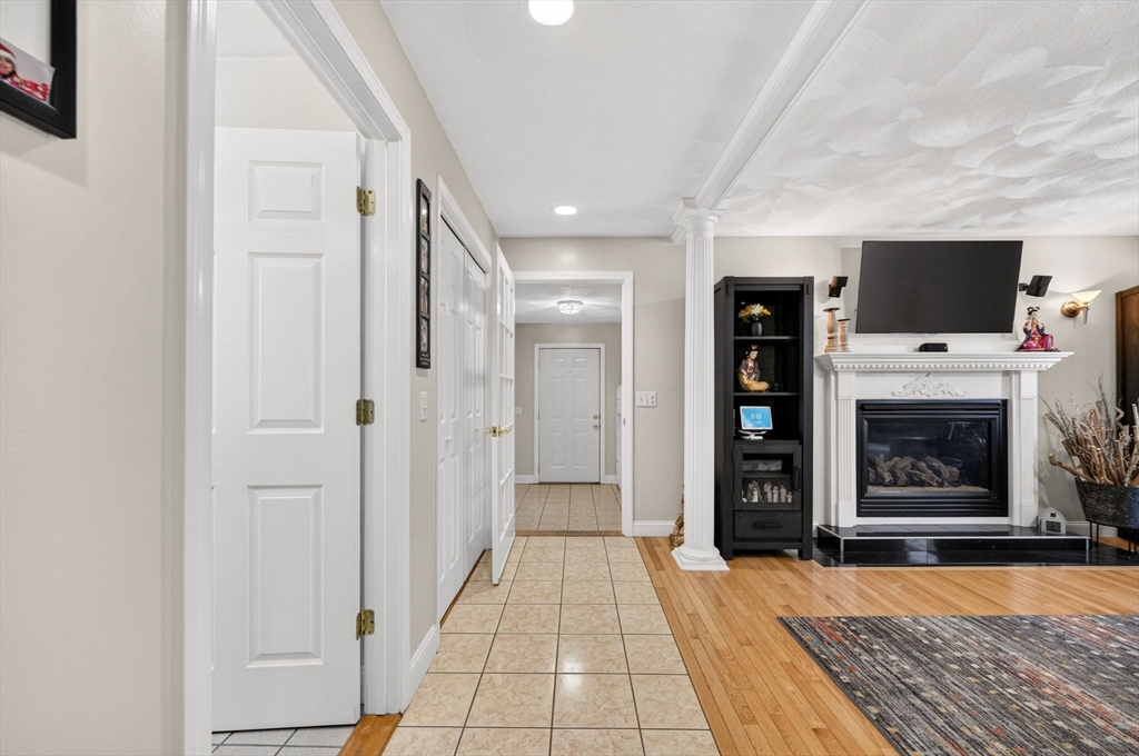 155 Sagamore Road Seekonk, MA 02771 - Photo 6 of 41 a living room with stainless steel appliances furniture a fireplace and a flat screen tv