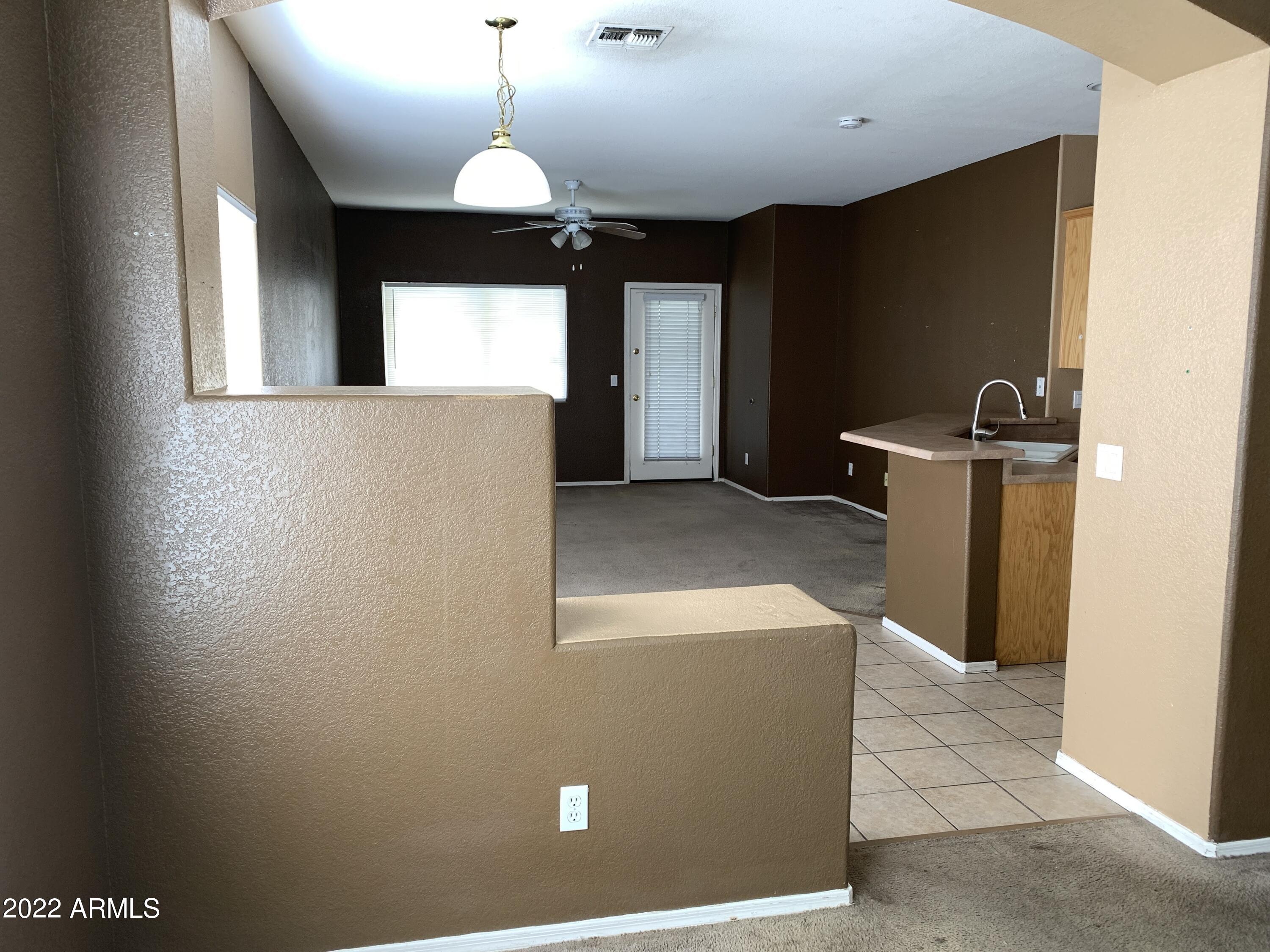 810 South 124th Avenue Avondale, AZ 85323 - Photo 4 of 18 a view of a livingroom with a chandelier