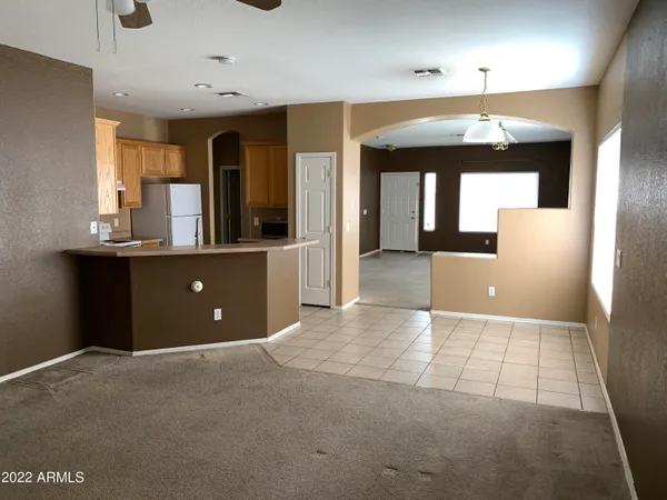 an open kitchen with a sink and chandelier