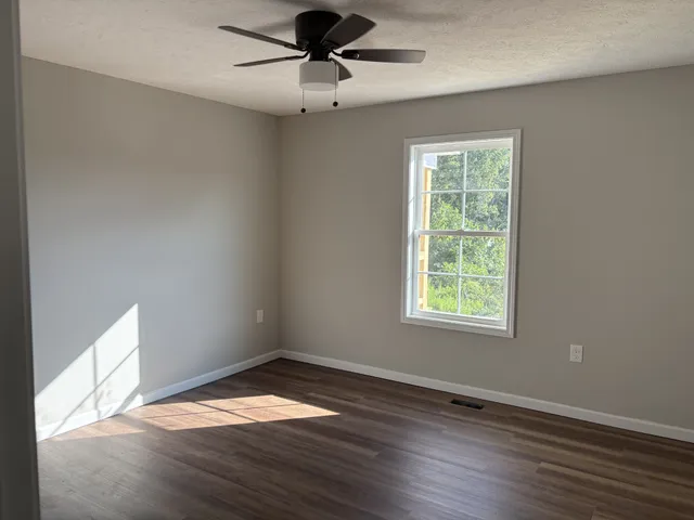 a kitchen with cabinets a sink and wooden floor