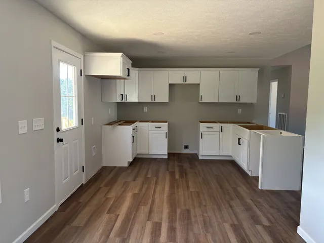 an empty room with a window and a ceiling fan