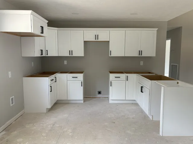 a kitchen with cabinets and white appliances