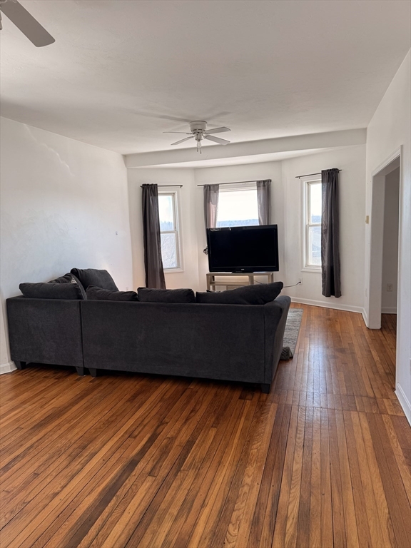 1442 Main Street, Unit 3 Worcester, MA 01603 - Photo 2 of 9 a living room with furniture and wooden floor