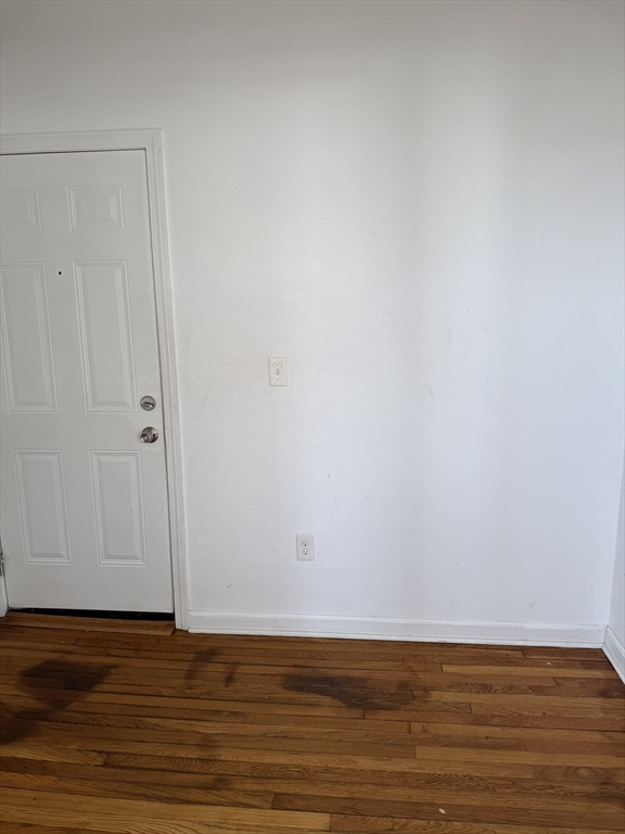 1442 Main Street, Unit 3 Worcester, MA 01603 - Photo 6 of 9 a view of an empty room with wooden floor and a window