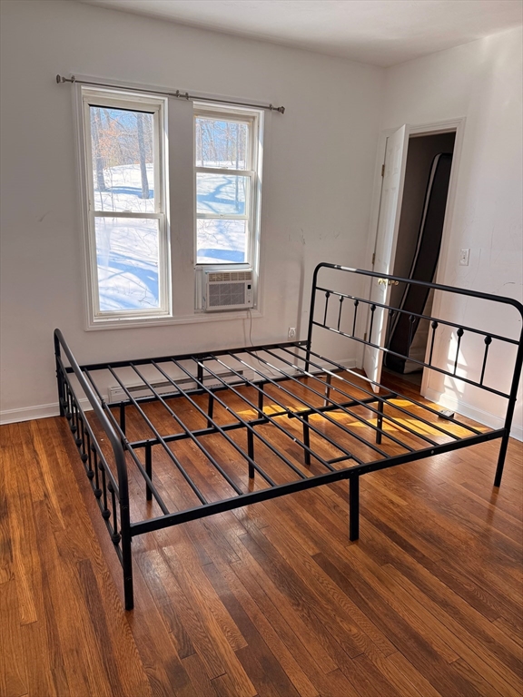 1442 Main Street, Unit 3 Worcester, MA 01603 - Photo 8 of 9 a living room with a bed furniture and a window