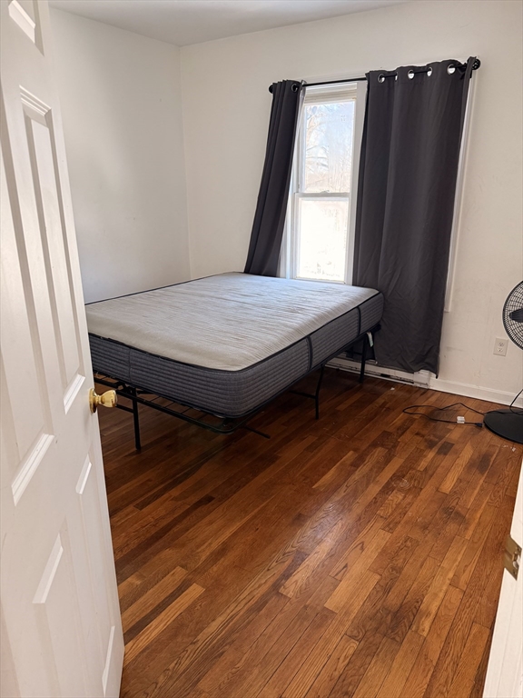 1442 Main Street, Unit 3 Worcester, MA 01603 - Photo 9 of 9 a bed sitting in a bedroom next to a window