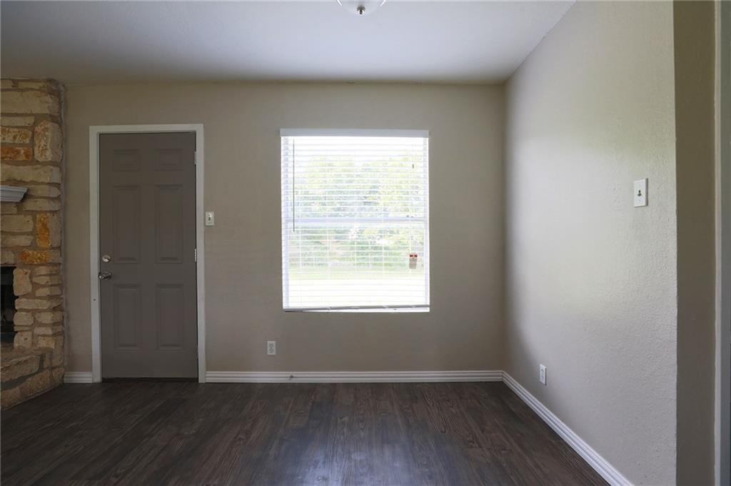 1410 Ransom Street Pflugerville, TX 78660 - Photo 4 of 22 a view of an empty room with wooden floor and a window