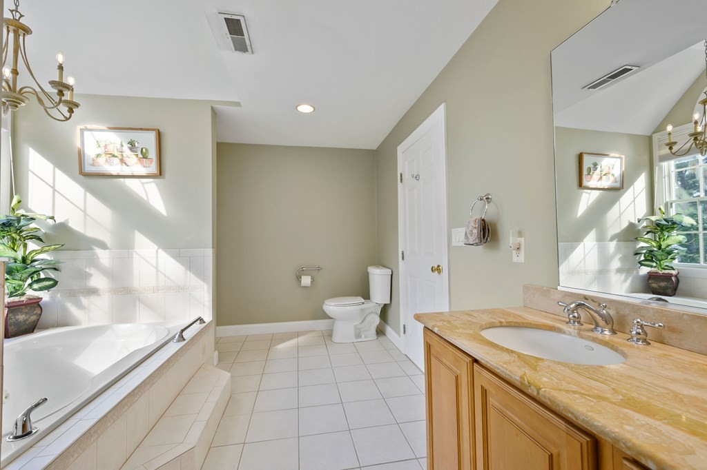 182 Boston Street Middleton, MA 01949 - Photo 36 of 42 a bathroom with a granite countertop sink and a mirror