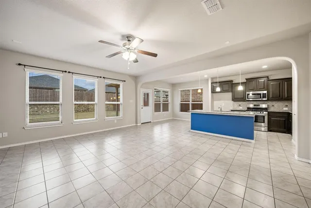a view of an empty room with a kitchen