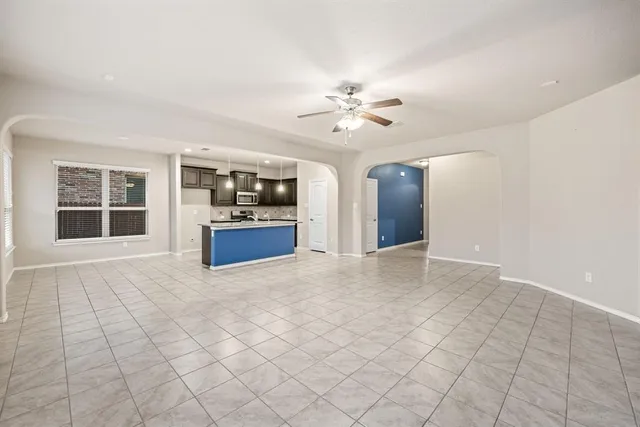 a kitchen with stainless steel appliances kitchen island granite countertop a stove and a sink