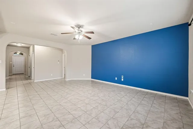 a large white kitchen with a stove top oven and cabinets