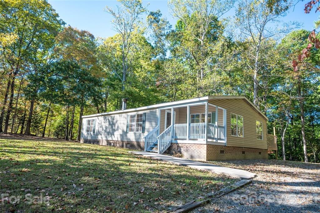 6550 Lewis Road Kings Mountain, NC 28086 - Photo 1 of 20 a front view of a house with garden