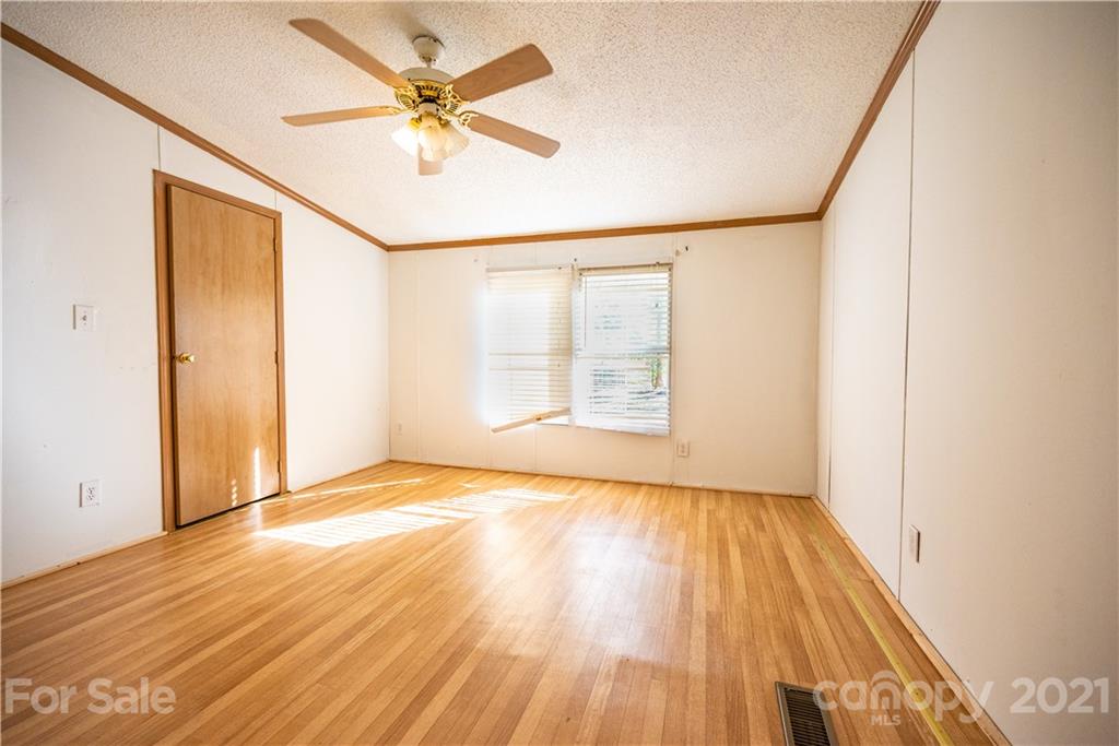 6550 Lewis Road Kings Mountain, NC 28086 - Photo 11 of 20 wooden floor in an empty room with a window