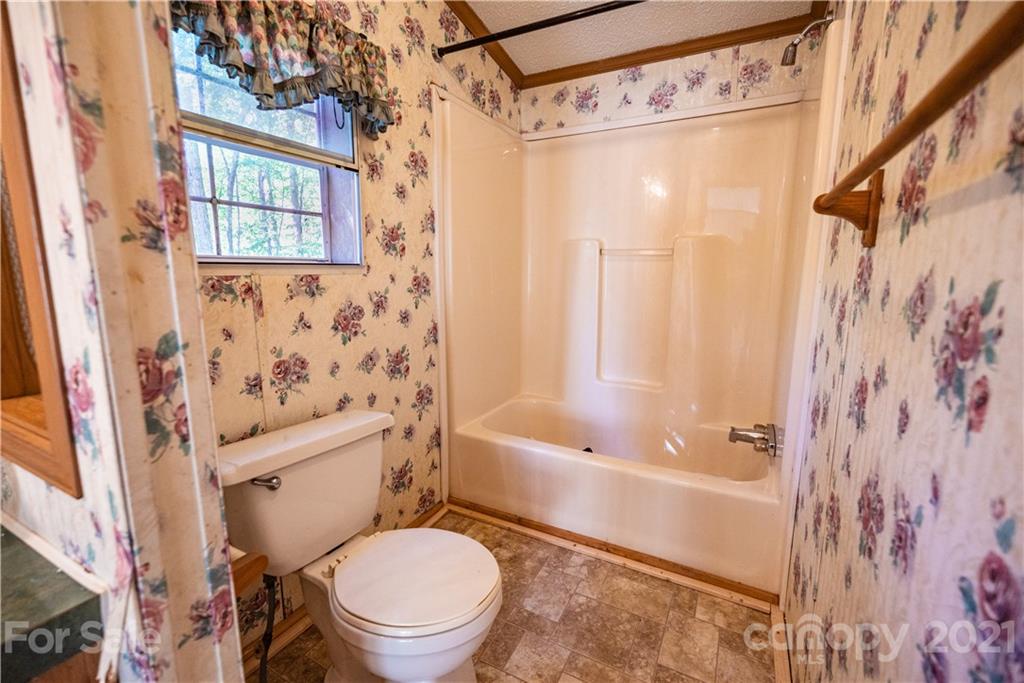 6550 Lewis Road Kings Mountain, NC 28086 - Photo 17 of 20 a white toilet sitting next to a bath tub shower